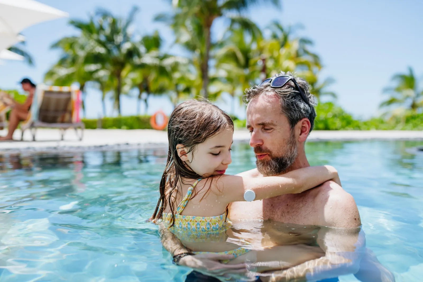 A parent and child enjoying time together in the pool